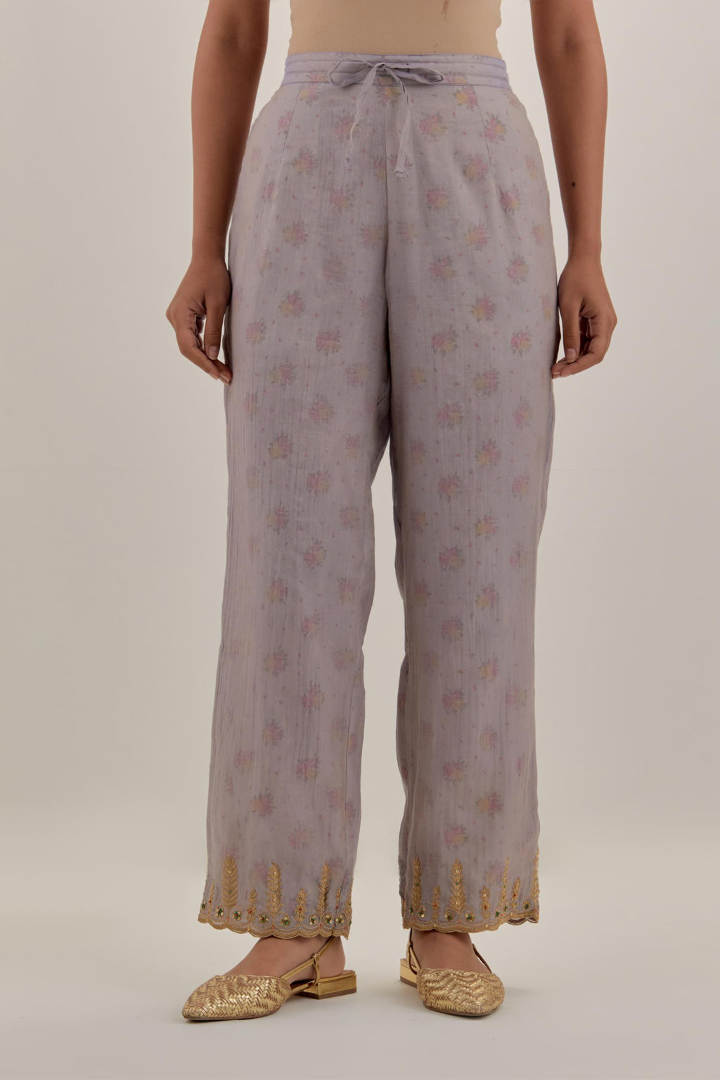 Lilac tissue chanderi straight pants with light gold dori embroidery at hem.