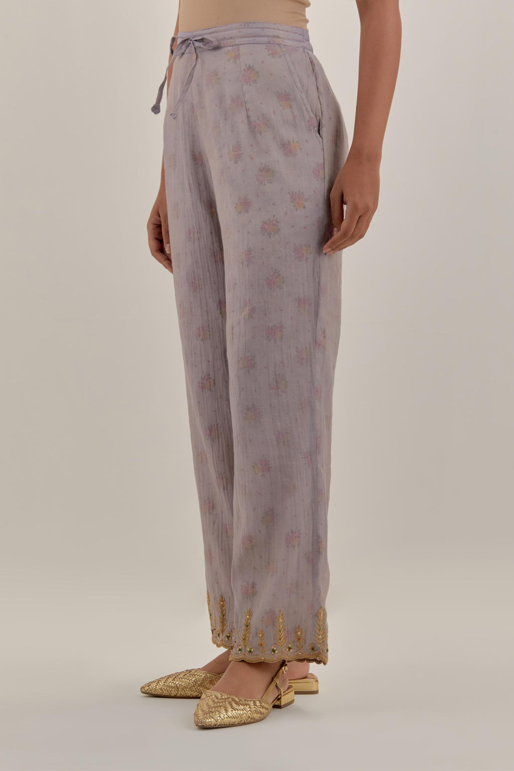 Lilac tissue chanderi straight pants with light gold dori embroidery at hem.