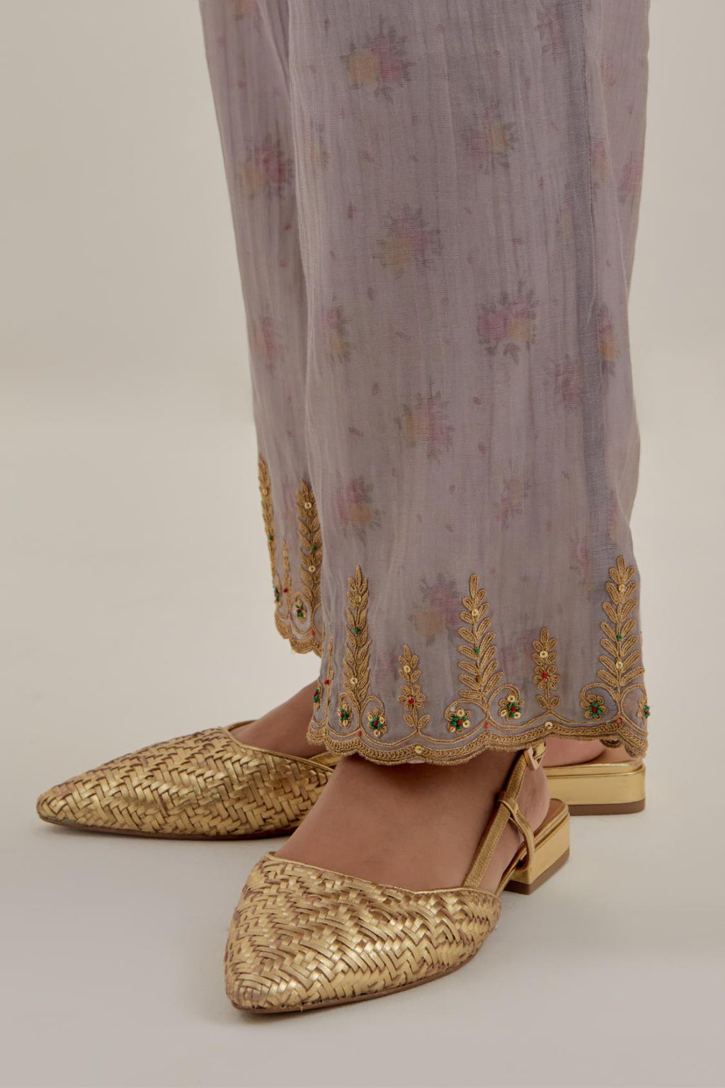 Lilac tissue chanderi straight pants with light gold dori embroidery at hem.