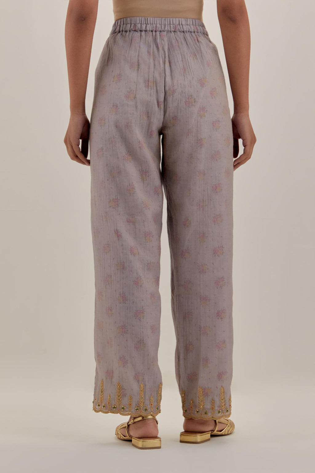 Lilac tissue chanderi straight pants with light gold dori embroidery at hem.