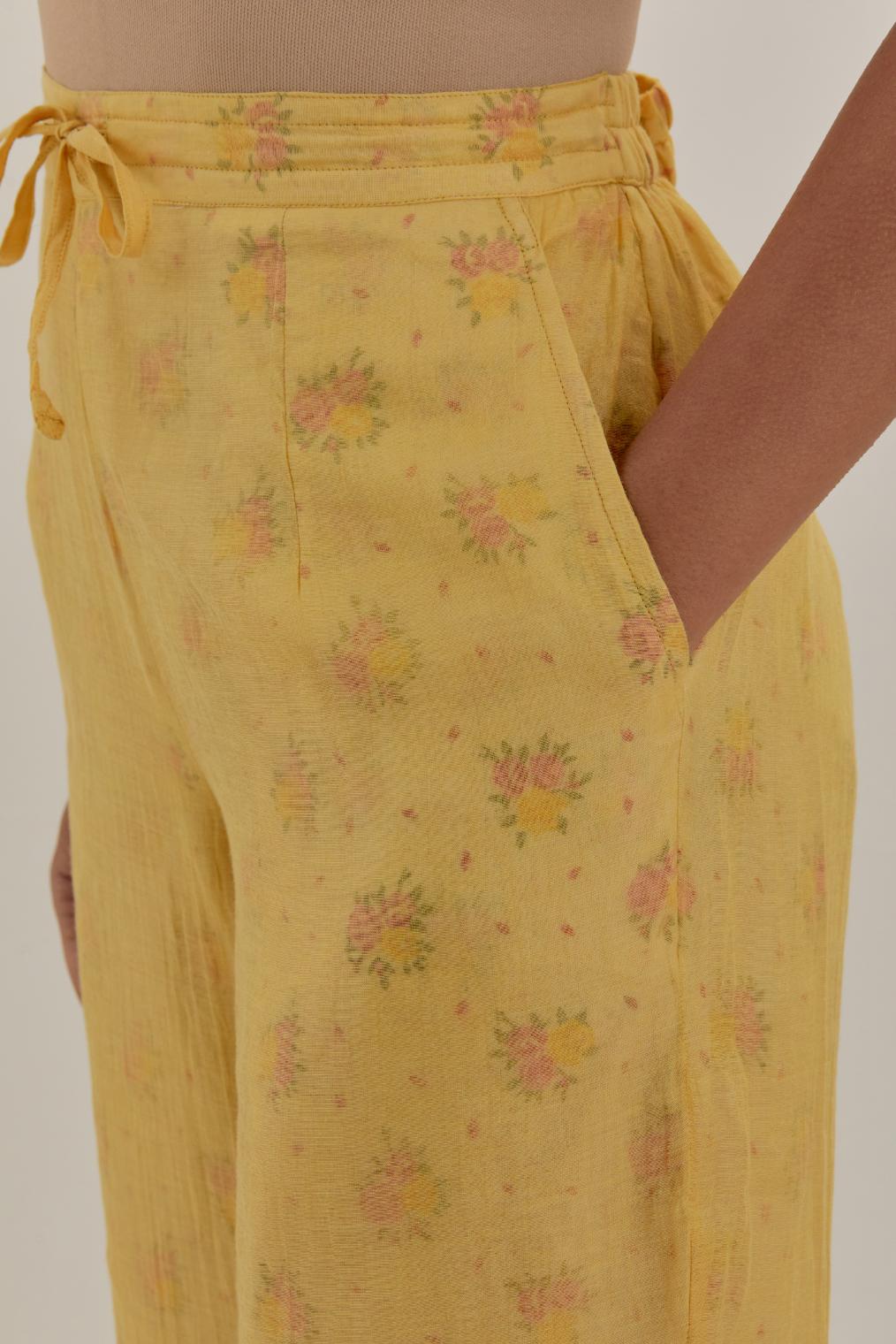 Yellow tissue chanderi straight pants with light gold dori embroidery at hem.