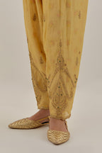 Yellow tissue chanderi salwar with gold dori embroidery, highlighted with multi beads & gold sequins.