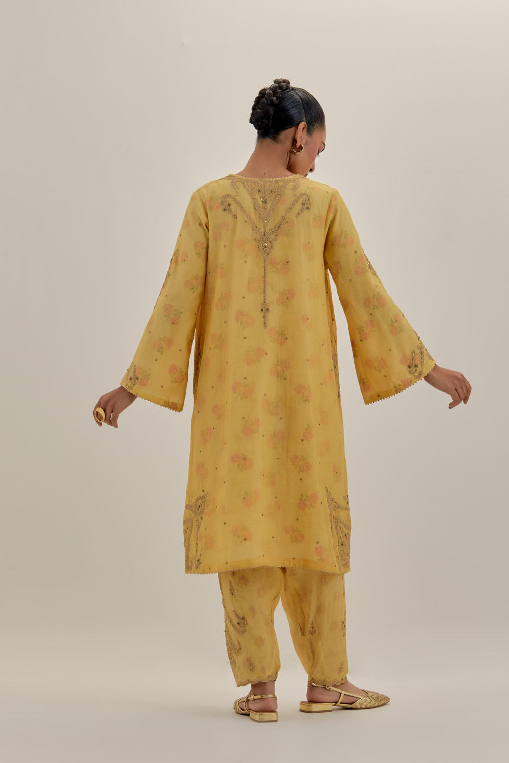 Yellow tissue chanderi A-line kurta set highlighted with light gold dori embroidery and hand block printed lining inside.