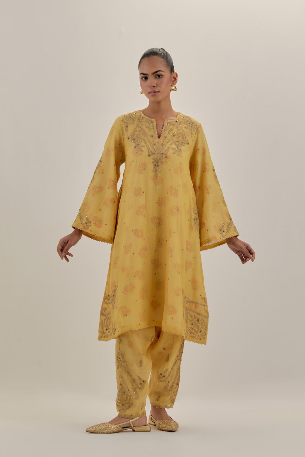 Yellow tissue chanderi A-line kurta set highlighted with light gold dori embroidery and hand block printed lining inside.