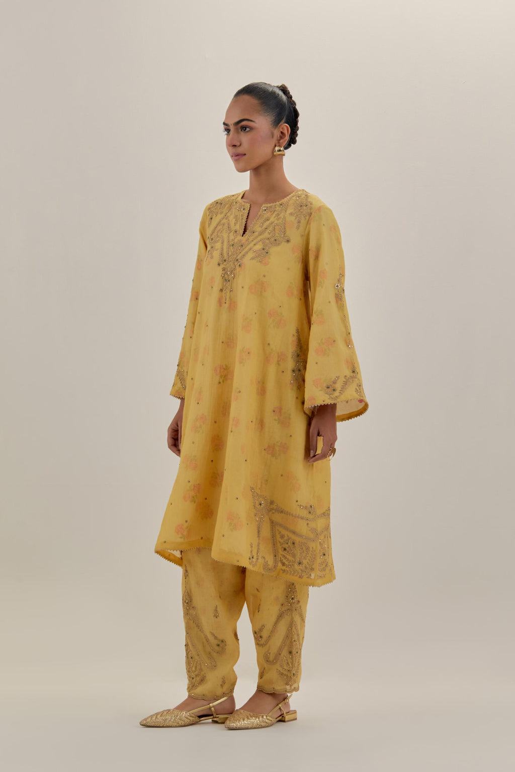 Yellow tissue chanderi A-line kurta set highlighted with light gold dori embroidery and hand block printed lining inside.