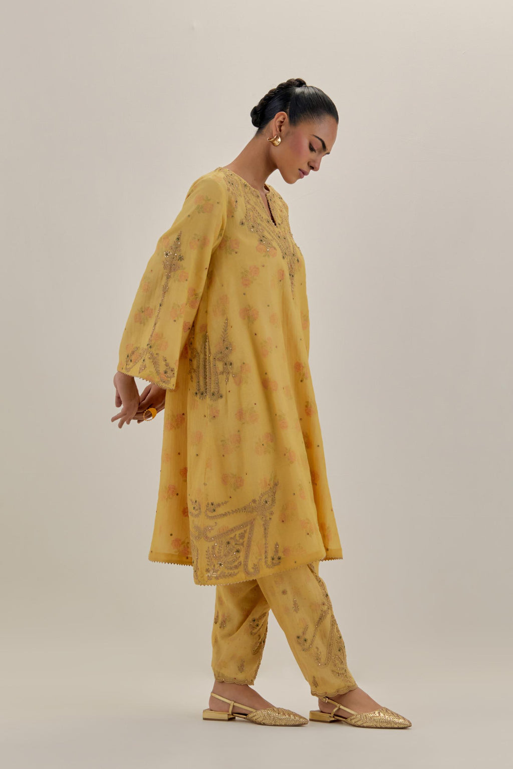 Yellow tissue chanderi A-line kurta set highlighted with light gold dori embroidery and hand block printed lining inside.