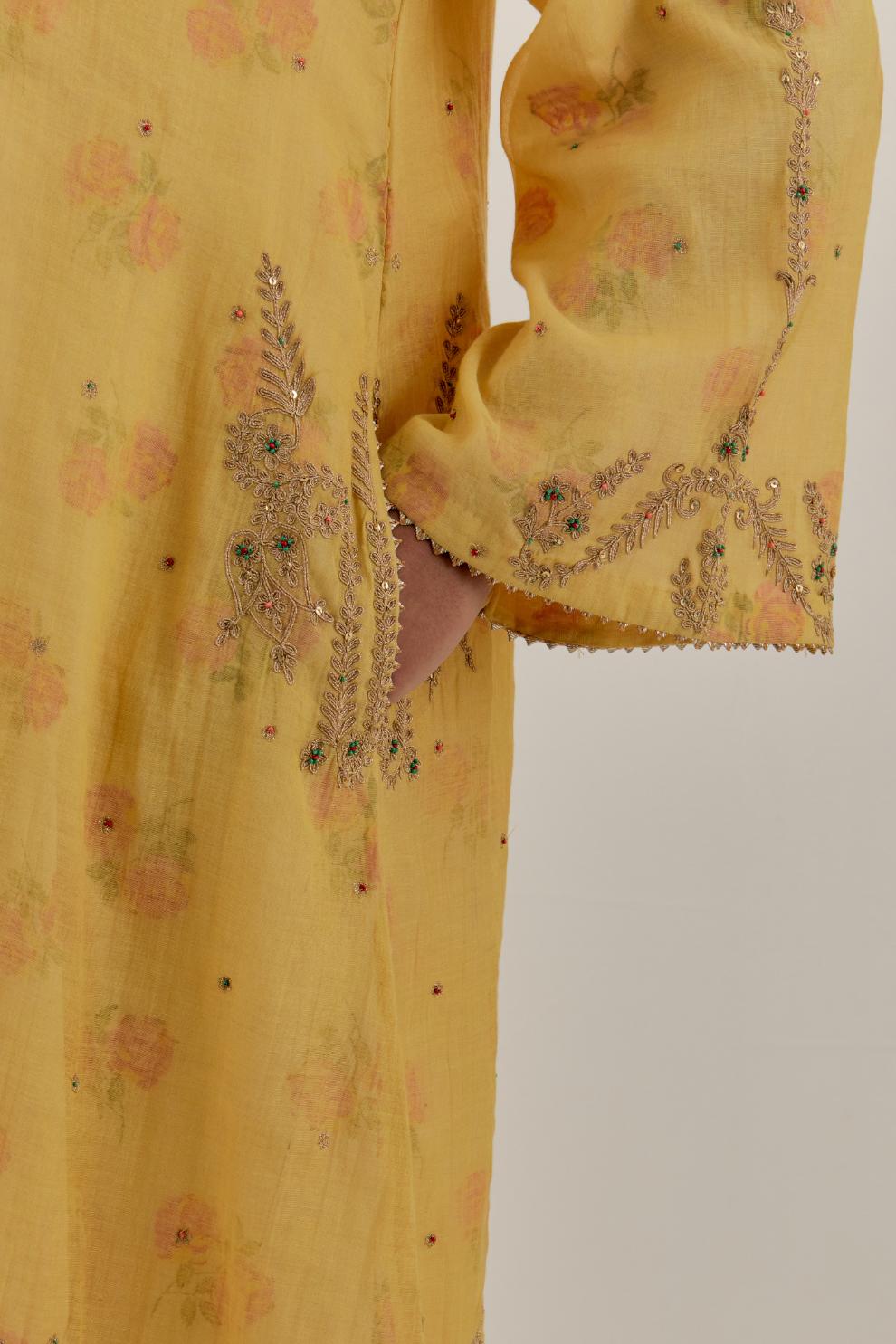 Yellow tissue chanderi A-line kurta set highlighted with light gold dori embroidery and hand block printed lining inside.