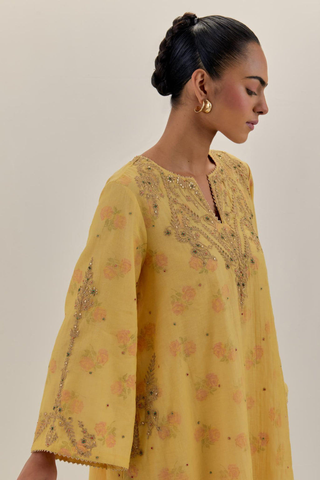 Yellow tissue chanderi A-line kurta set highlighted with light gold dori embroidery and hand block printed lining inside.