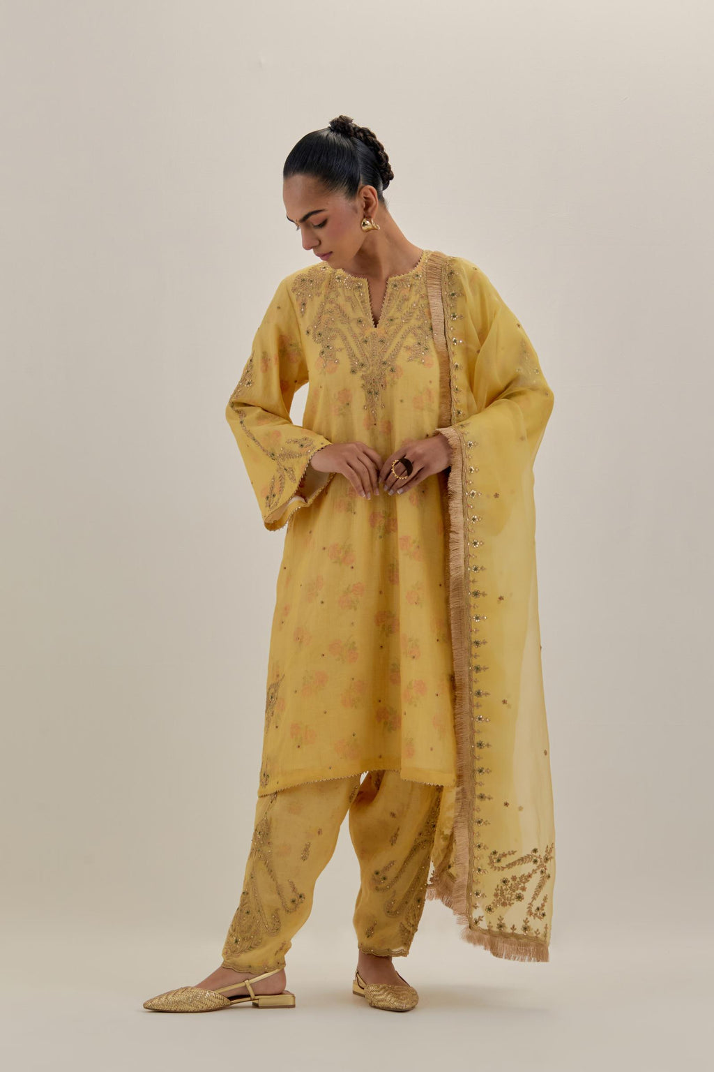 Yellow tissue chanderi A-line kurta set highlighted with light gold dori embroidery and hand block printed lining inside.