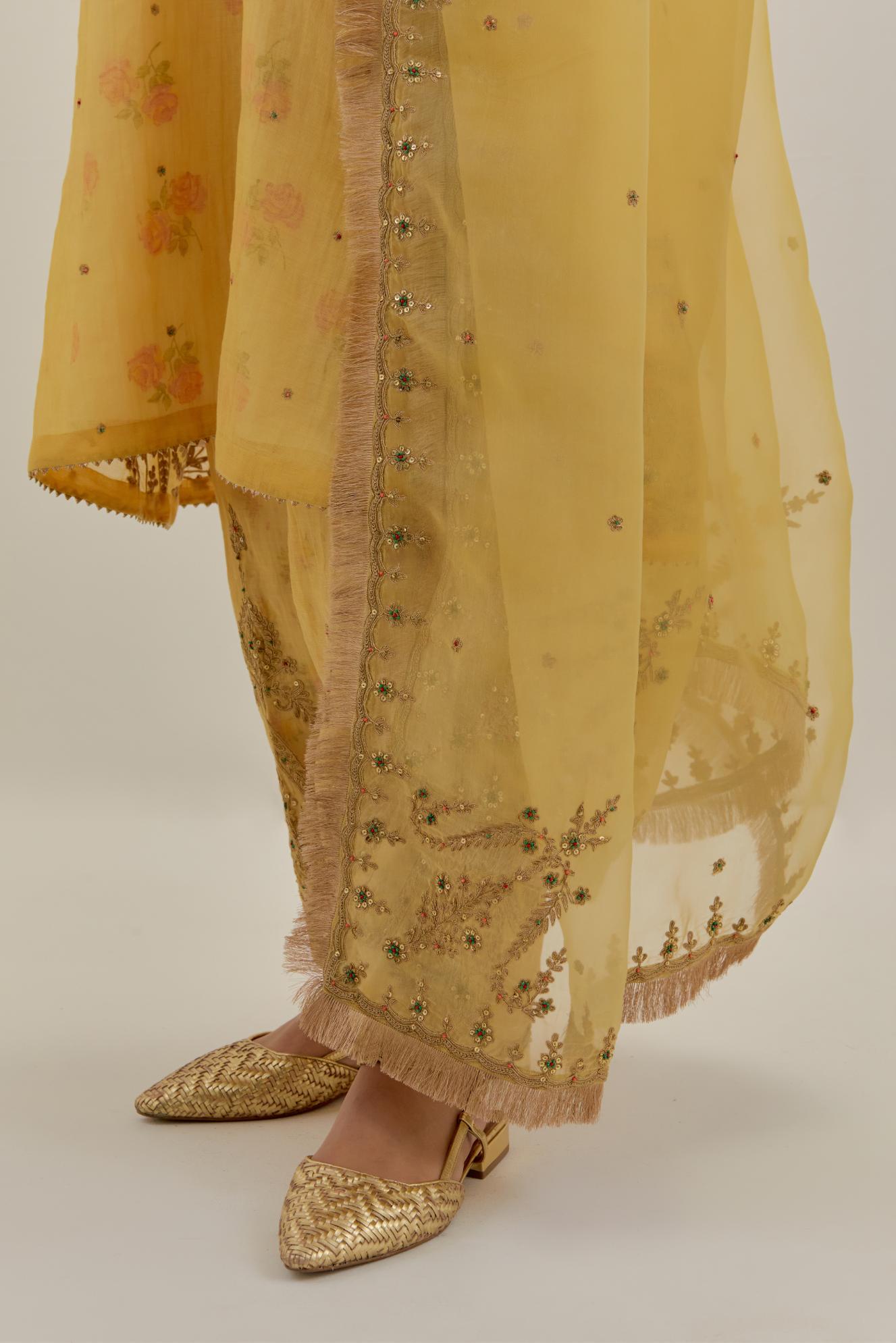 Yellow tissue chanderi A-line kurta set highlighted with light gold dori embroidery and hand block printed lining inside.