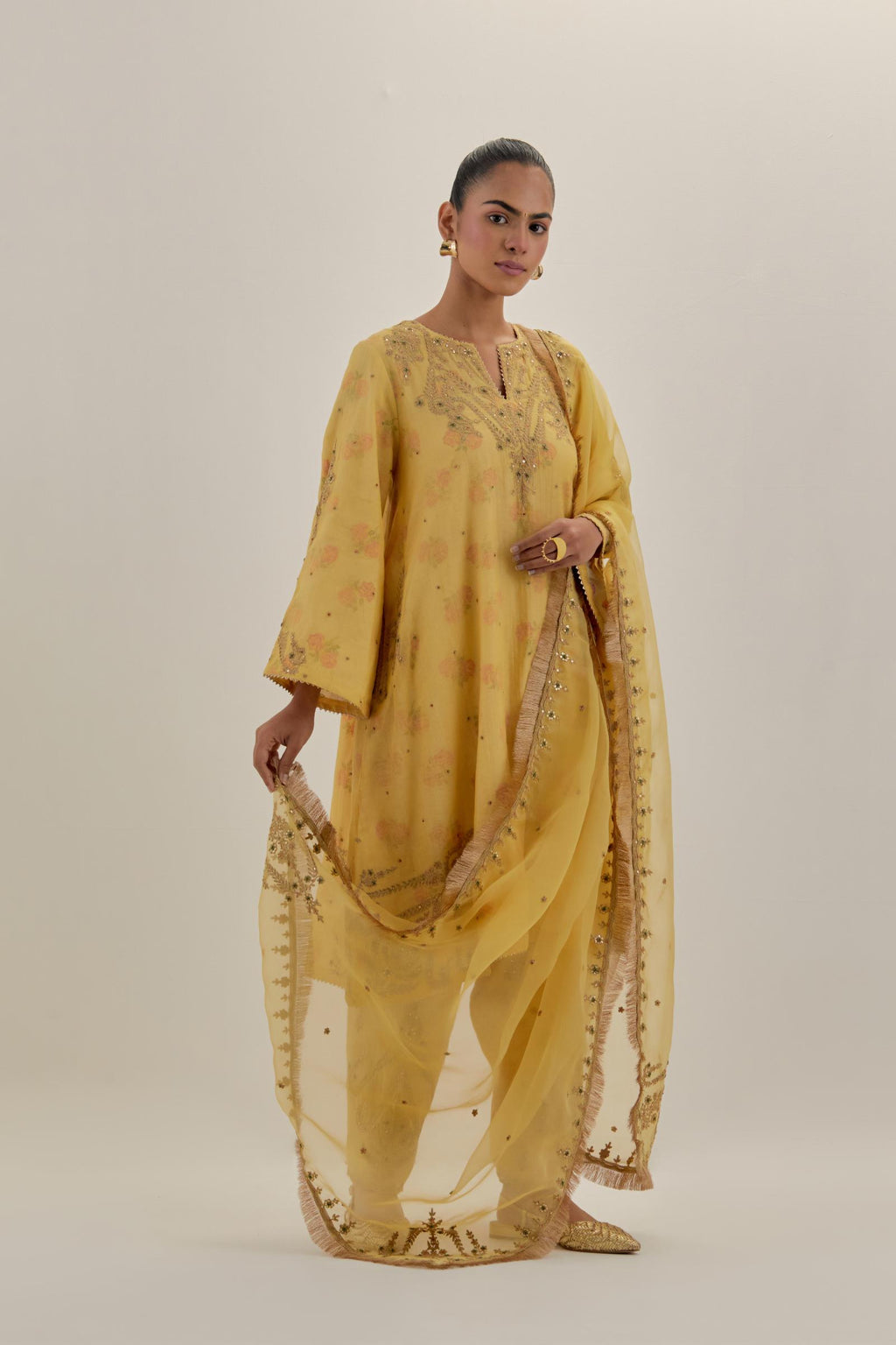 Yellow tissue chanderi A-line kurta set highlighted with light gold dori embroidery and hand block printed lining inside.