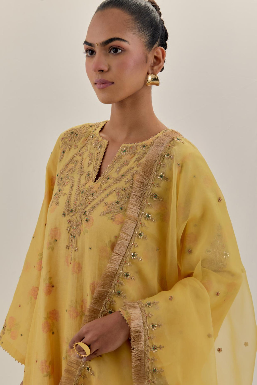 Yellow tissue chanderi A-line kurta set highlighted with light gold dori embroidery and hand block printed lining inside.