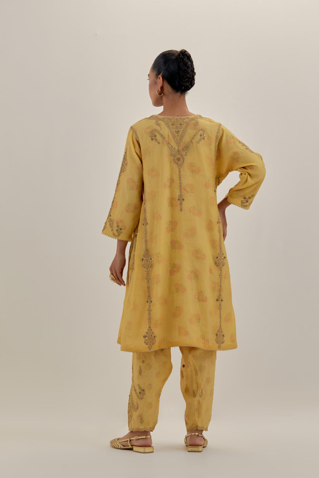 Yellow tissue chanderi easy fit short kalidar kurta set with light gold dori embroidery and hand block printed lining inside.