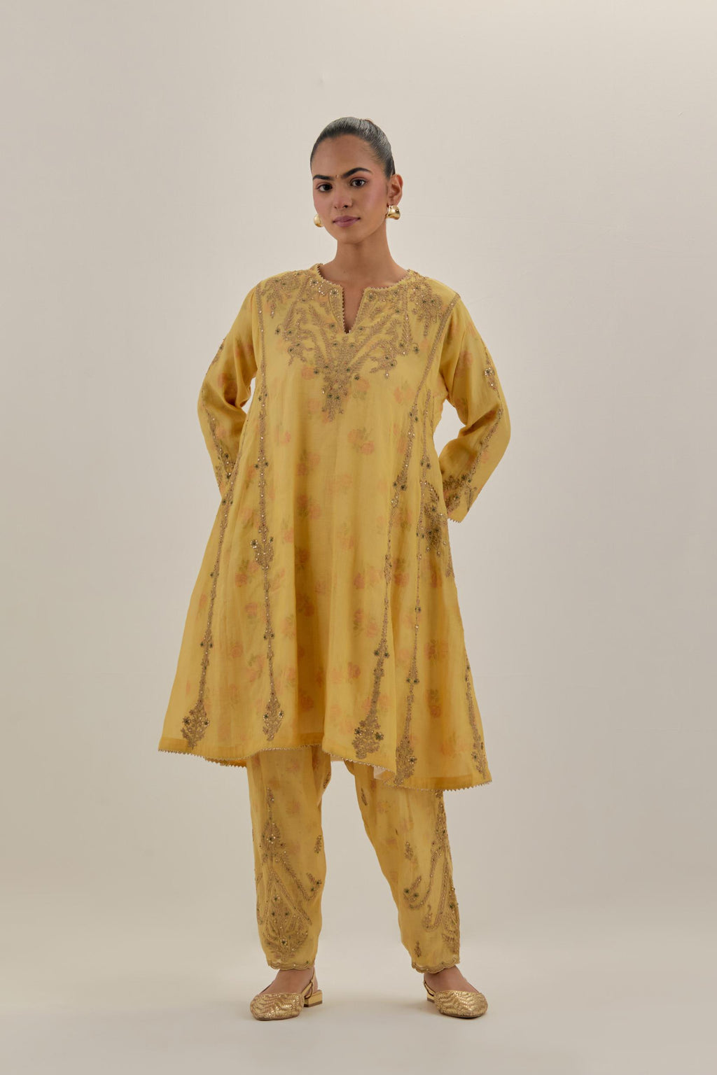 Yellow tissue chanderi easy fit short kalidar kurta set with light gold dori embroidery and hand block printed lining inside.