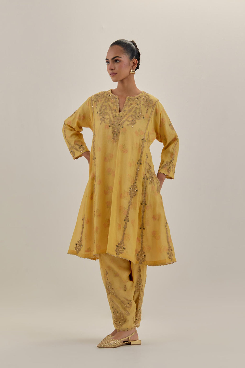 Yellow tissue chanderi easy fit short kalidar kurta set with light gold dori embroidery and hand block printed lining inside.