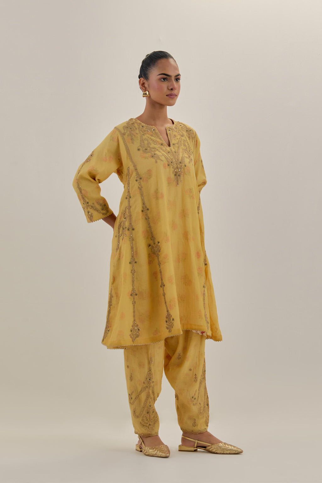 Yellow tissue chanderi easy fit short kalidar kurta set with light gold dori embroidery and hand block printed lining inside.