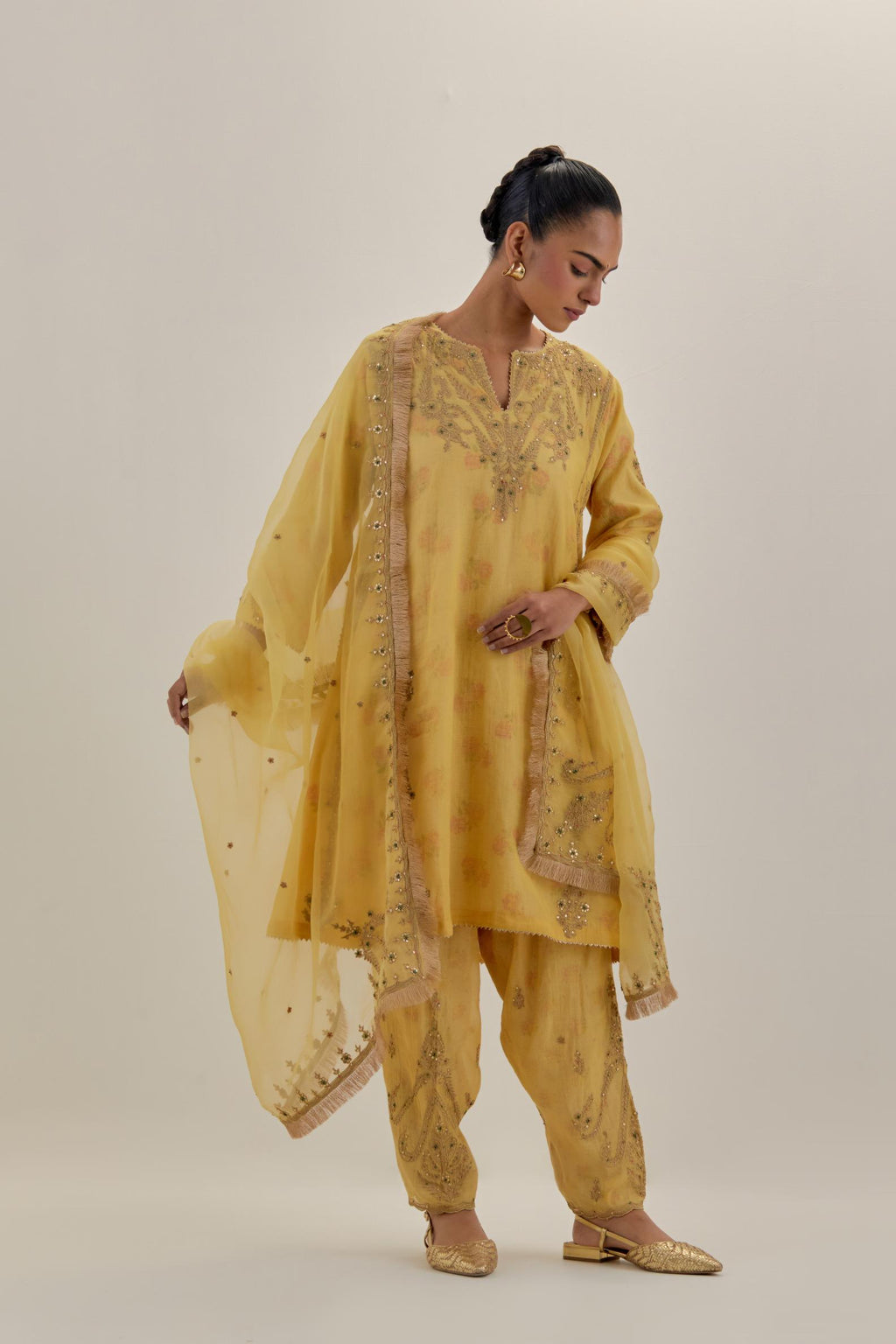 Yellow tissue chanderi easy fit short kalidar kurta set with light gold dori embroidery and hand block printed lining inside.