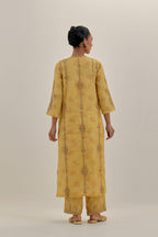 Yellow tissue chanderi straight kurta set with light gold dori embroidery, highlighted with multi color bead sequins work.