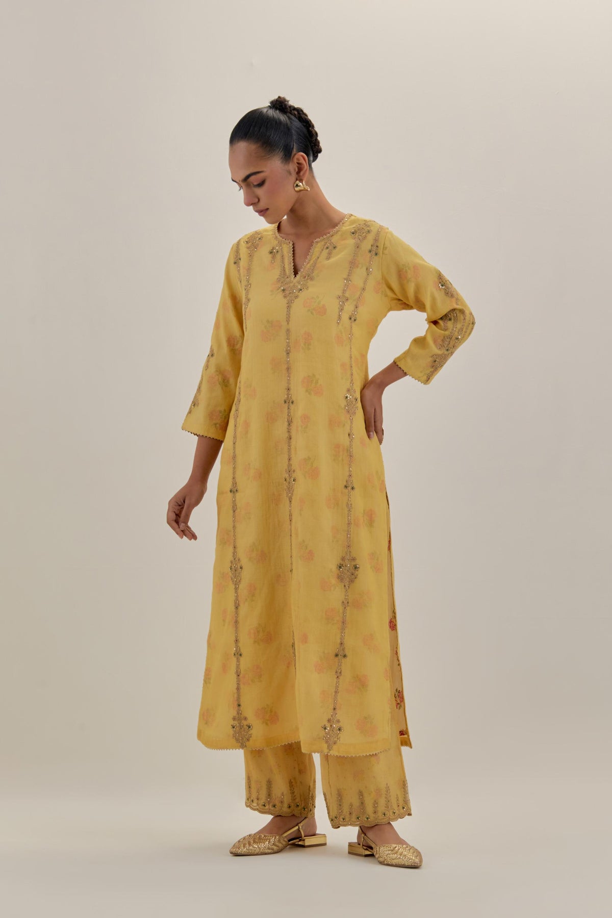Yellow tissue chanderi straight kurta set with light gold dori embroidery, highlighted with multi color bead sequins work.