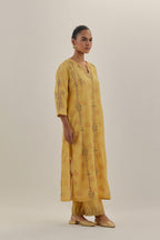 Yellow tissue chanderi straight kurta set with light gold dori embroidery, highlighted with multi color bead sequins work.