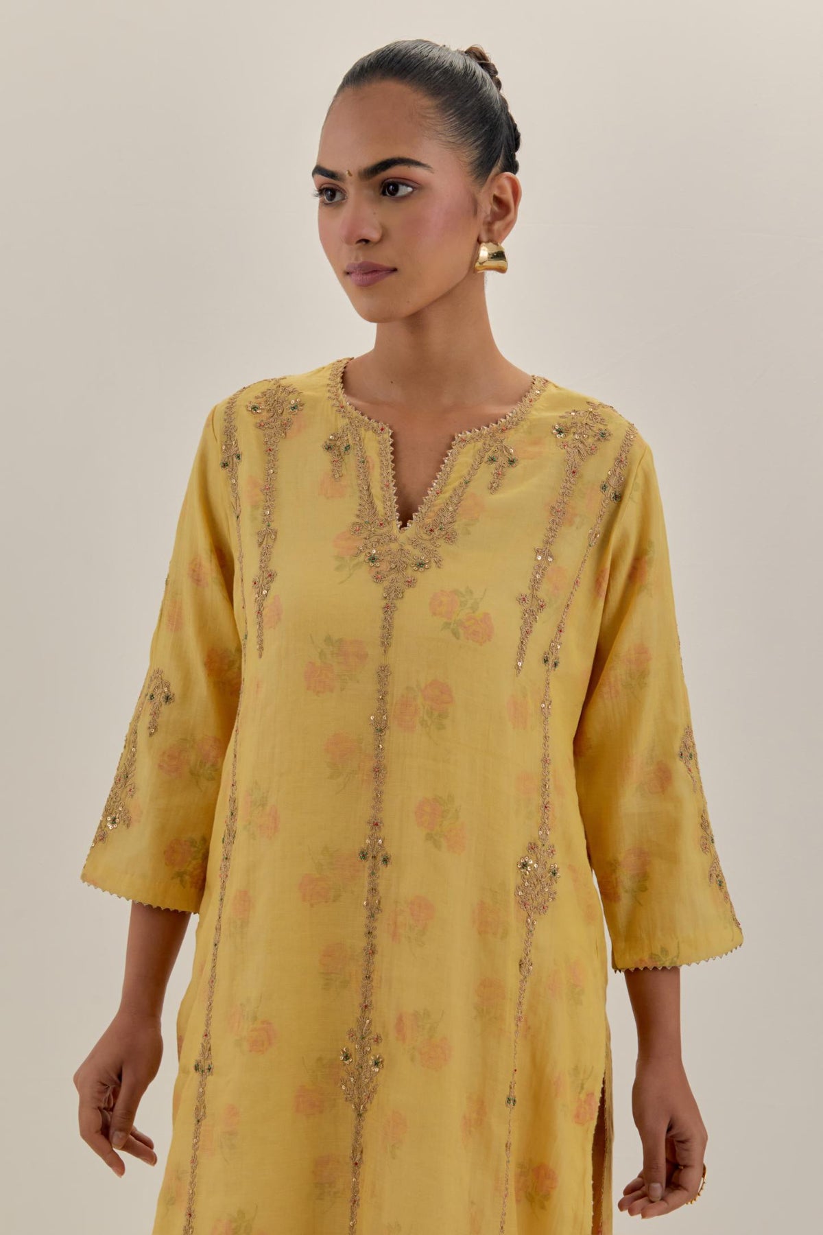 Yellow tissue chanderi straight kurta set with light gold dori embroidery, highlighted with multi color bead sequins work.