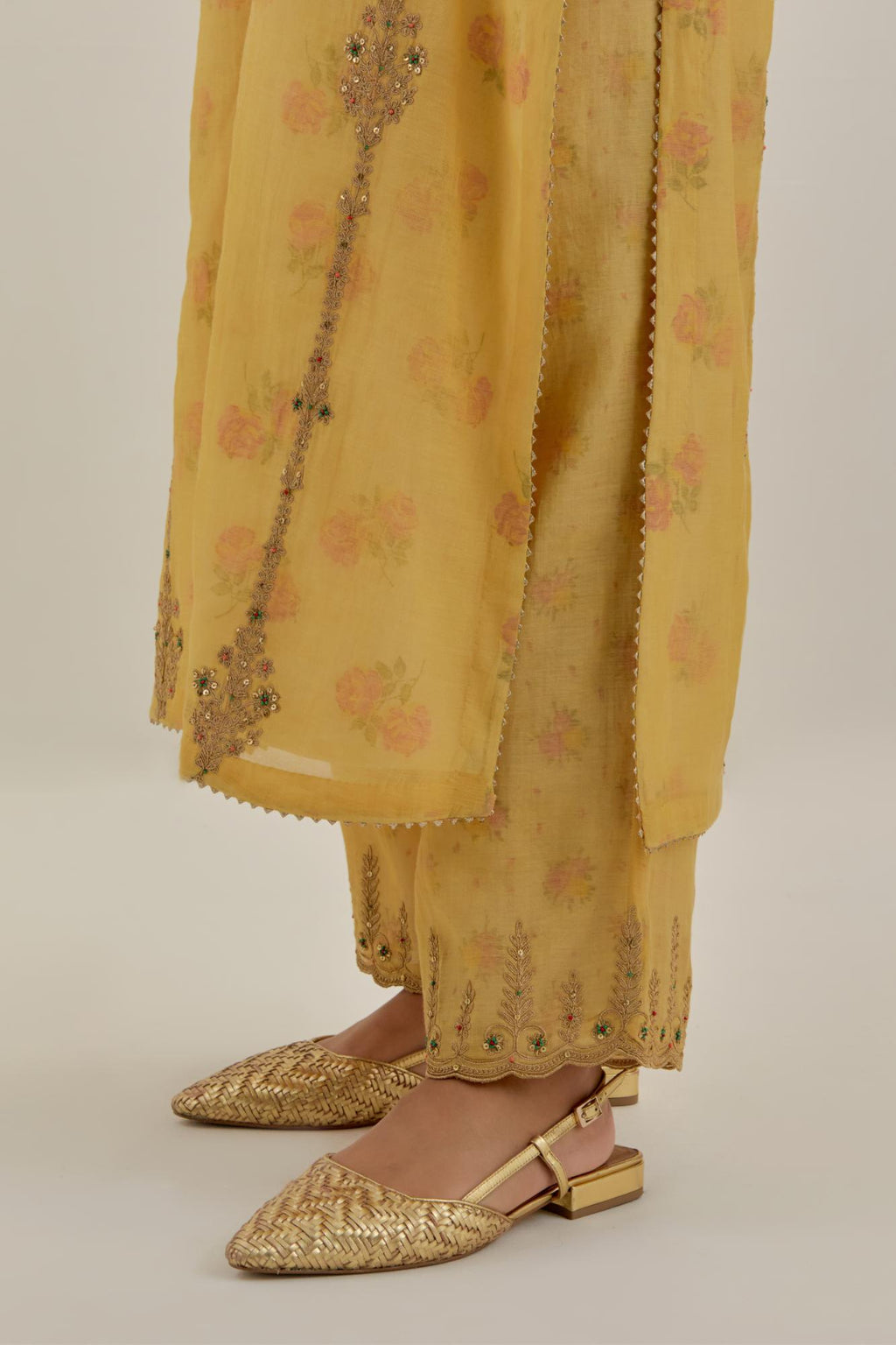 Yellow tissue chanderi straight kurta set with light gold dori embroidery, highlighted with multi color bead sequins work.