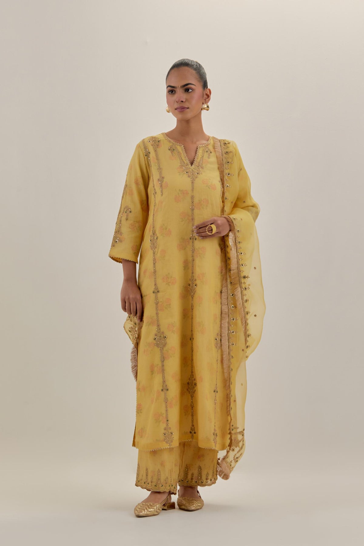Yellow tissue chanderi straight kurta set with light gold dori embroidery, highlighted with multi color bead sequins work.