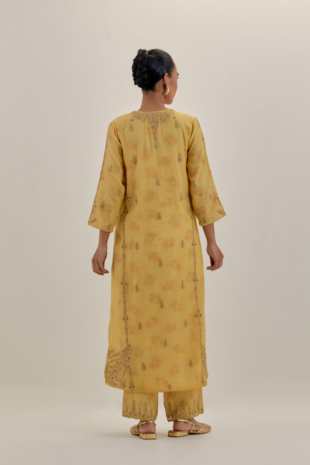 Yellow tissue chanderi straight kurta set with button placket neckline, highlighted with all-over light gold dori embroidery.