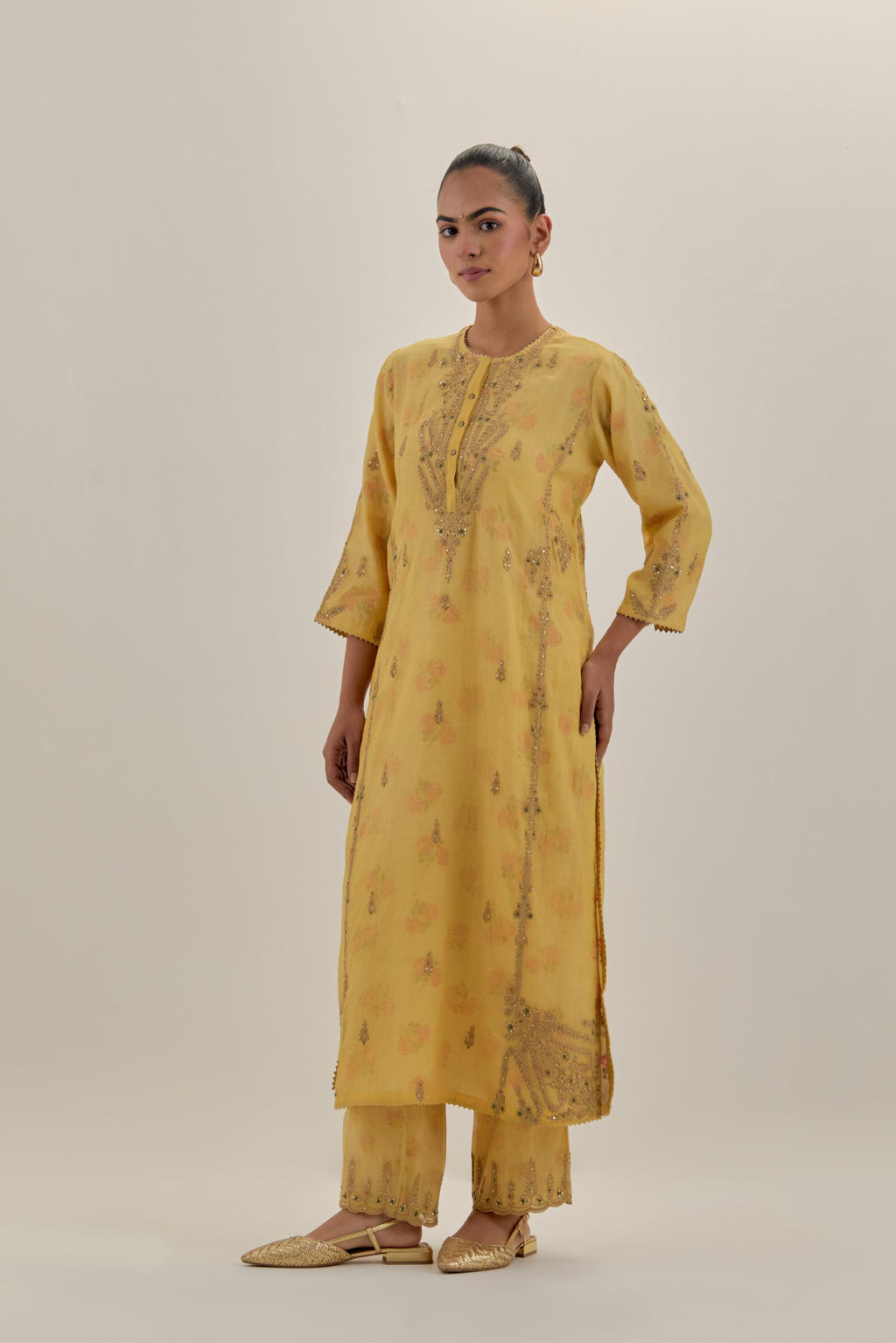 Yellow tissue chanderi straight kurta set with button placket neckline, highlighted with all-over light gold dori embroidery.