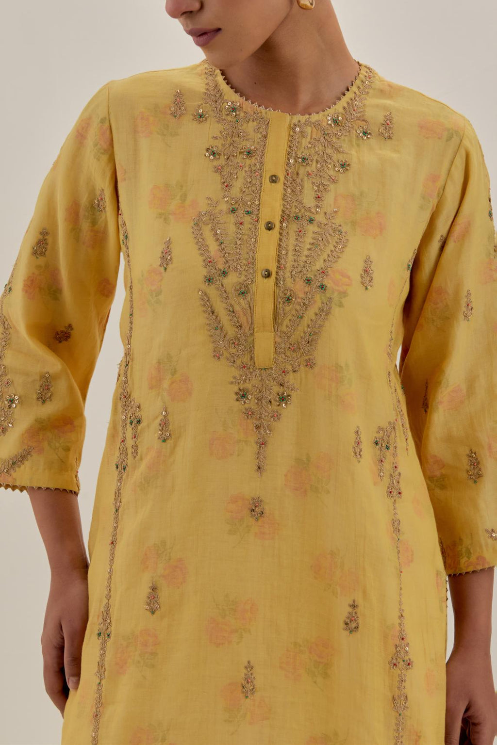 Yellow tissue chanderi straight kurta set with button placket neckline, highlighted with all-over light gold dori embroidery.