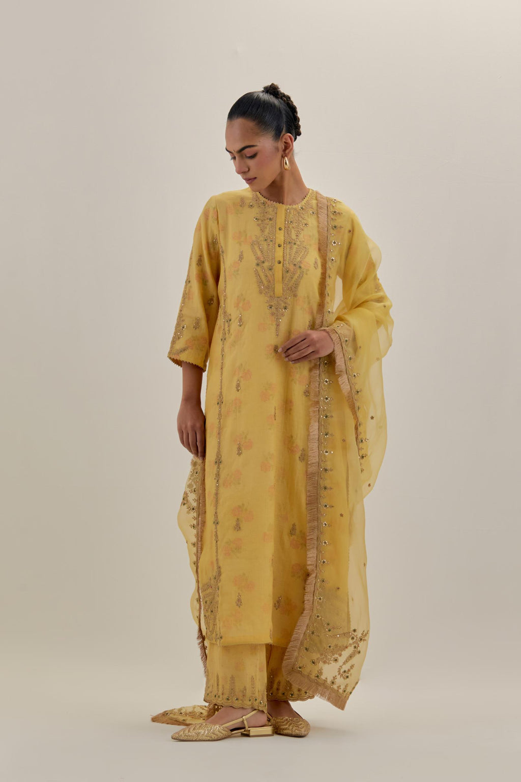 Yellow tissue chanderi straight kurta set with button placket neckline, highlighted with all-over light gold dori embroidery.