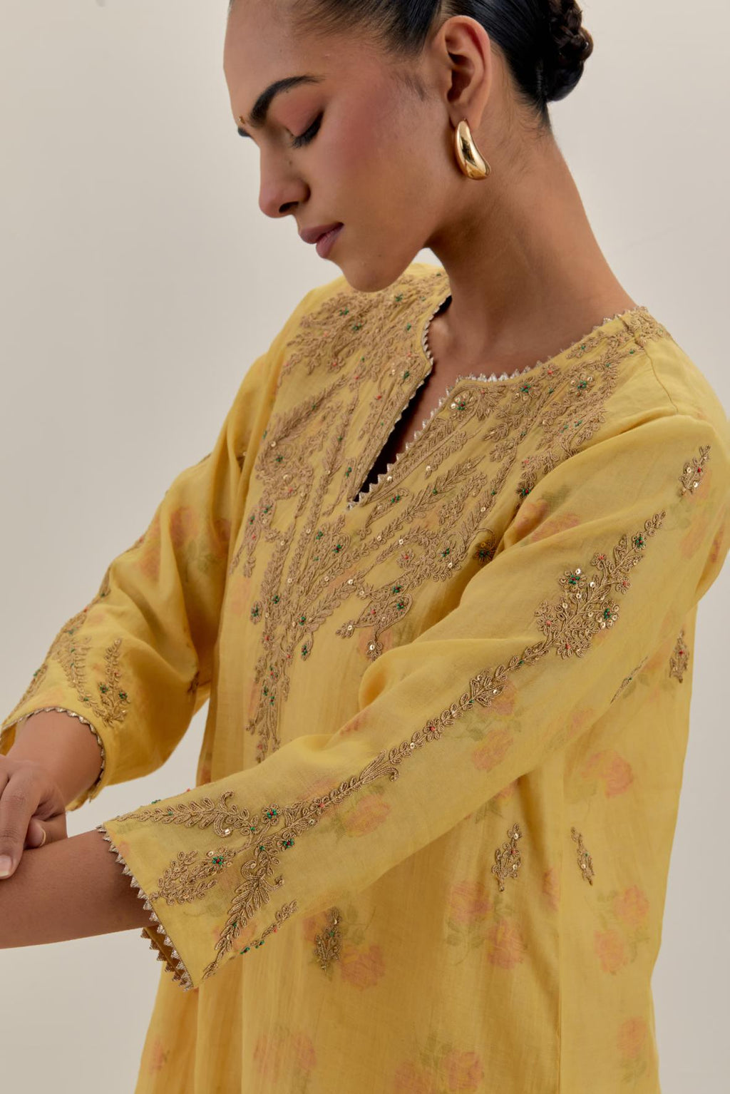 Yellow tissue chanderi straight kurta set, highlighted with light gold dori embroidery and hand block printed lining inside.