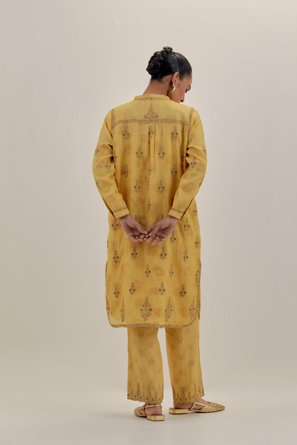 Yellow tissue chanderi straight short kurta set with all-over light gold dori embroidery.