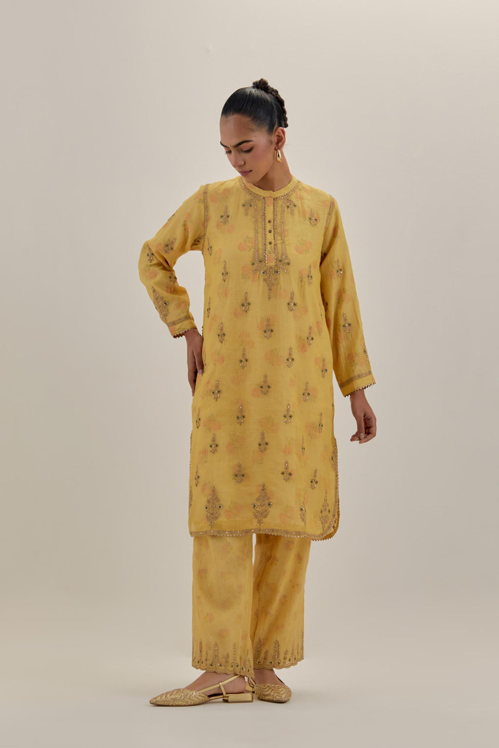 Yellow tissue chanderi straight short kurta set with all-over light gold dori embroidery.