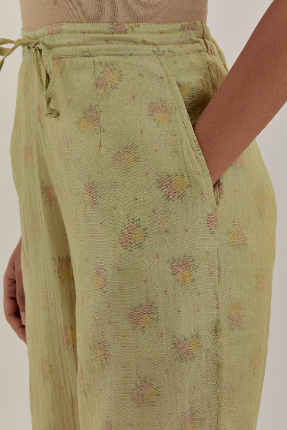 Green tissue chanderi straight pants with light gold dori embroidery at hem.