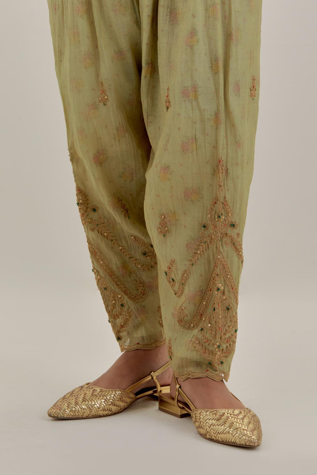 Green tissue chanderi A-line kurta set highlighted with light gold dori embroidery and hand block printed lining inside.