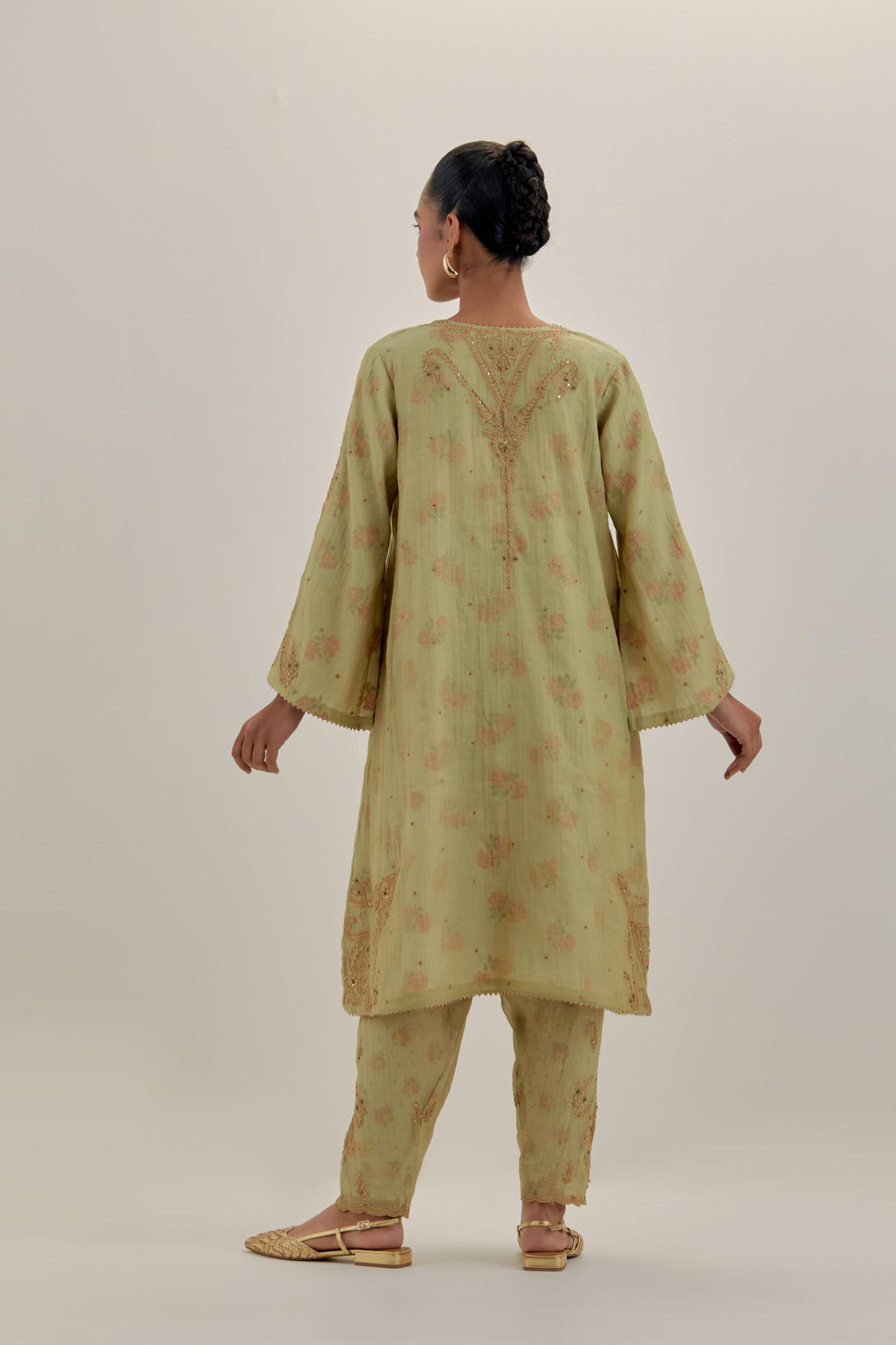 Green tissue chanderi A-line kurta set highlighted with light gold dori embroidery and hand block printed lining inside.