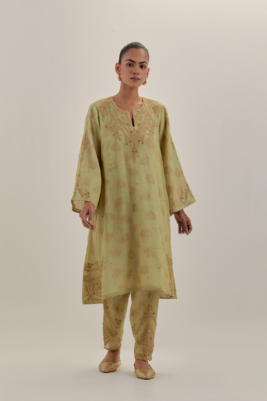 Green tissue chanderi A-line kurta set highlighted with light gold dori embroidery and hand block printed lining inside.