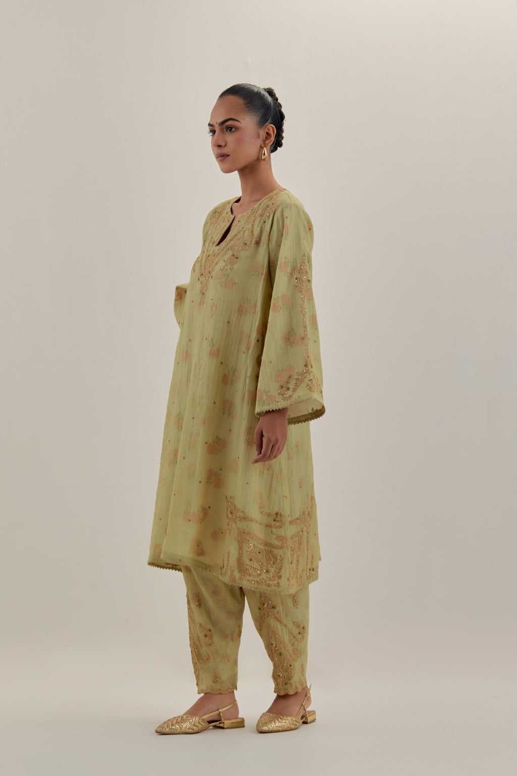 Green tissue chanderi A-line kurta set highlighted with light gold dori embroidery and hand block printed lining inside.