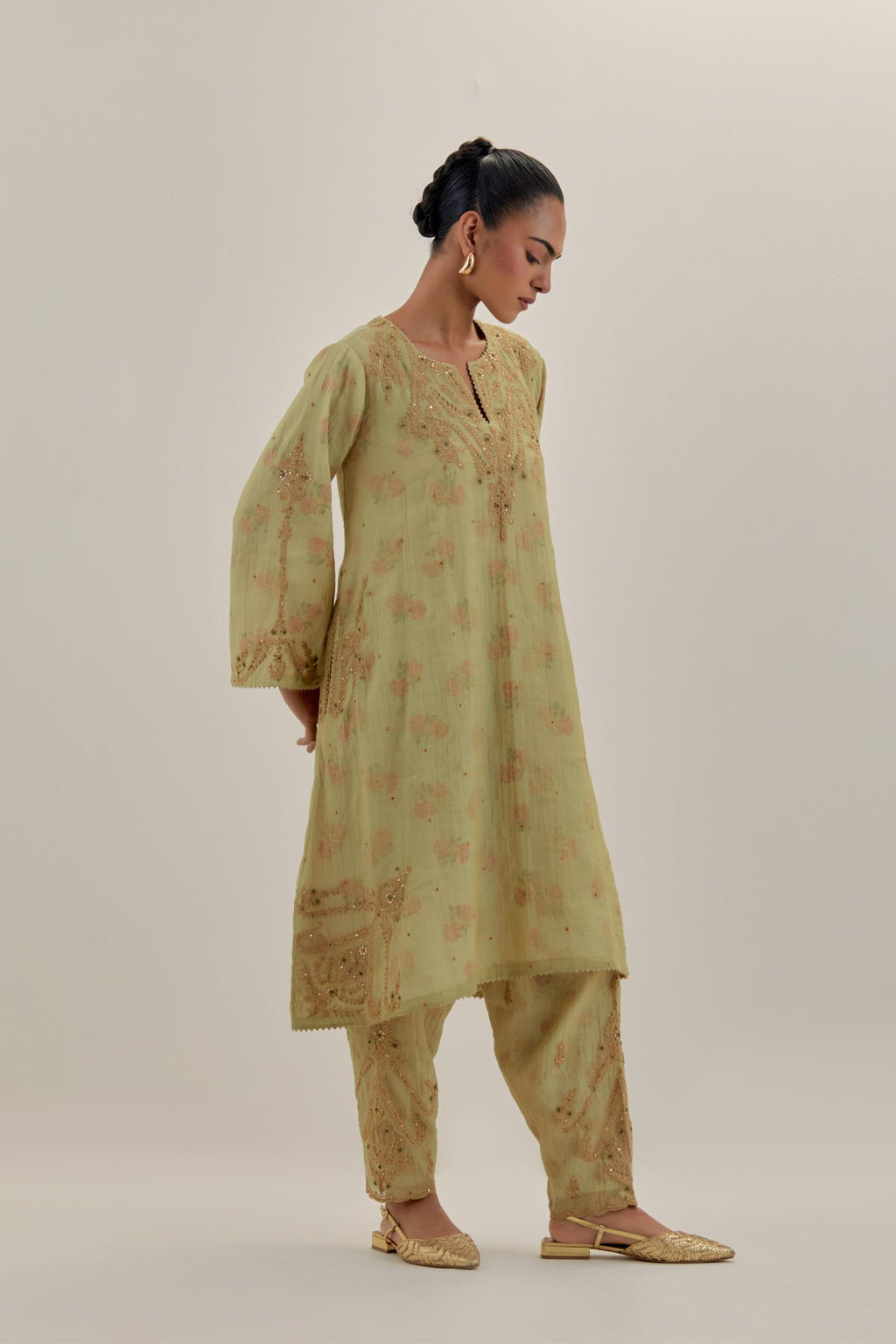 Green tissue chanderi A-line kurta set highlighted with light gold dori embroidery and hand block printed lining inside.