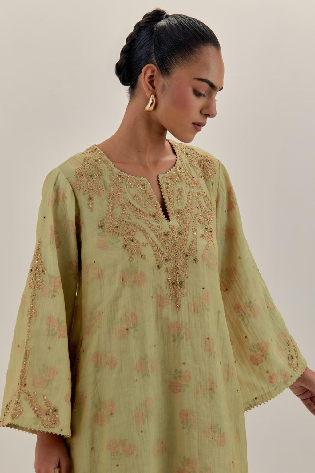 Green tissue chanderi A-line kurta set highlighted with light gold dori embroidery and hand block printed lining inside.