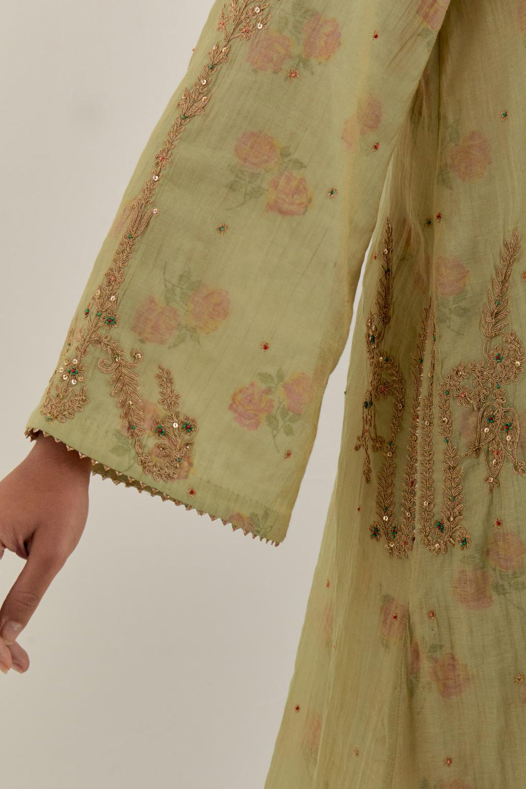 Green tissue chanderi A-line kurta set highlighted with light gold dori embroidery and hand block printed lining inside.