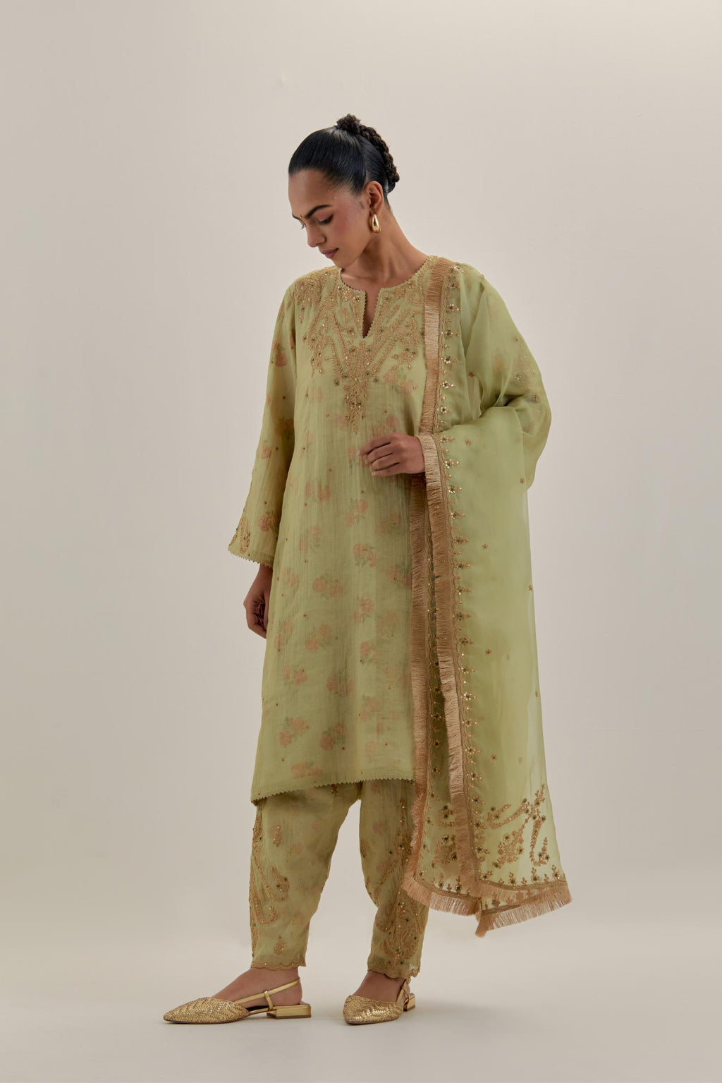 Green tissue chanderi A-line kurta set highlighted with light gold dori embroidery and hand block printed lining inside.