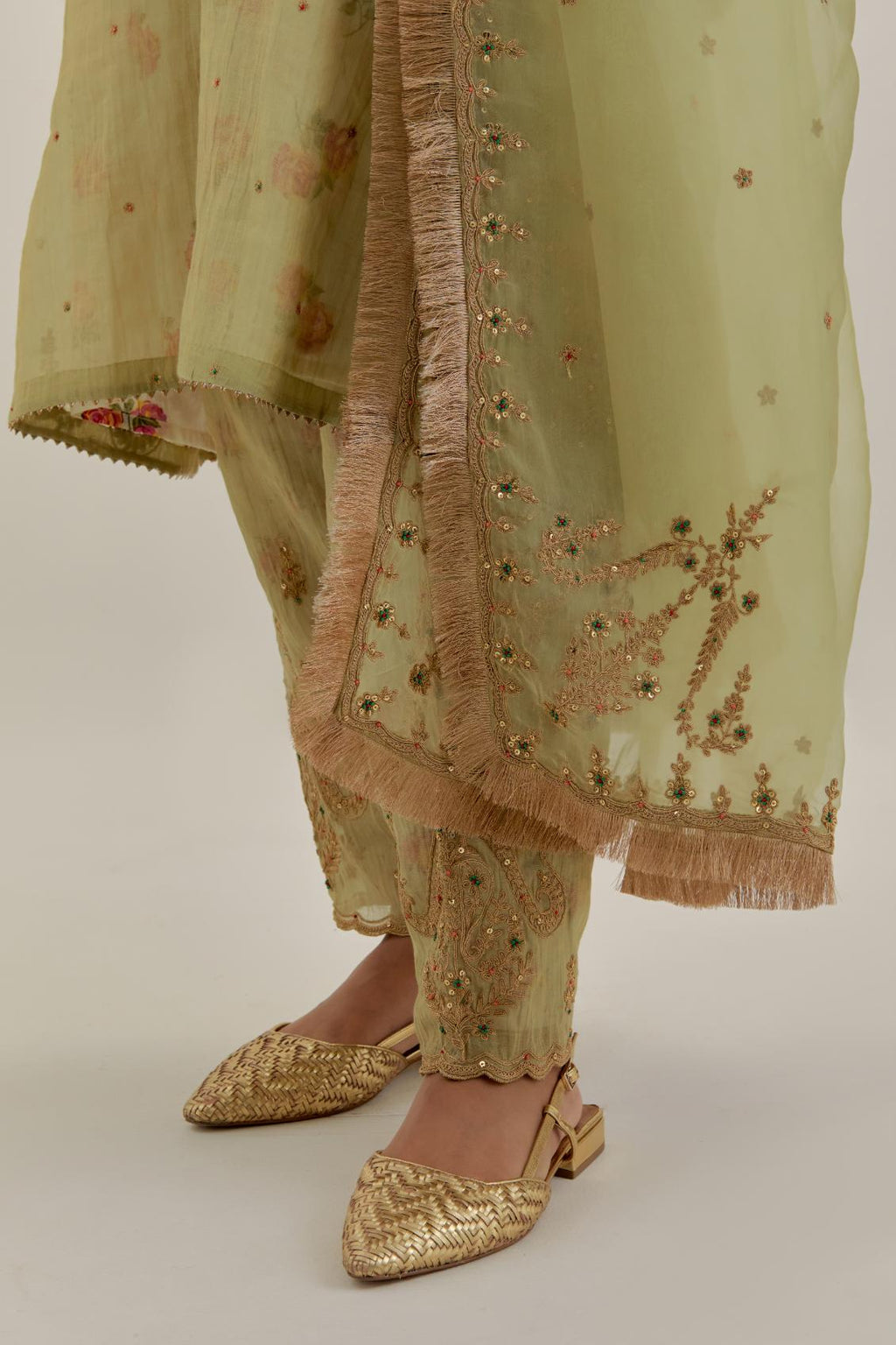 Green tissue chanderi A-line kurta set highlighted with light gold dori embroidery and hand block printed lining inside.