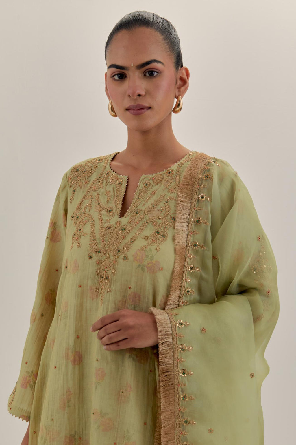 Green tissue chanderi A-line kurta set highlighted with light gold dori embroidery and hand block printed lining inside.