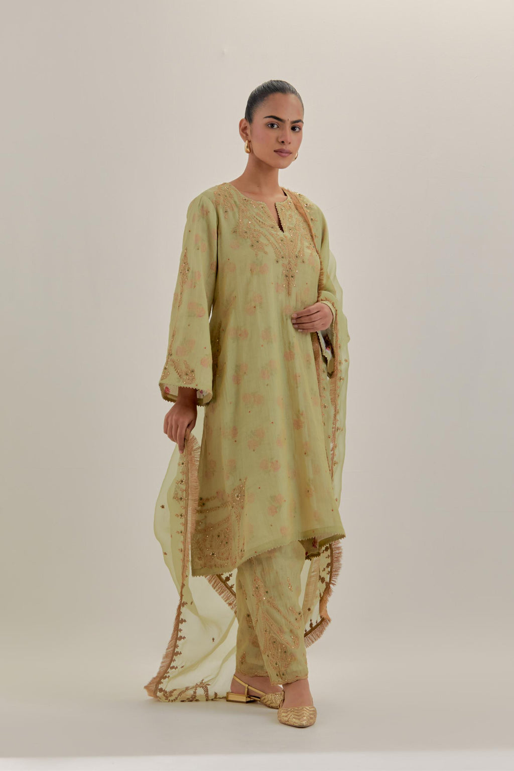 Green tissue chanderi A-line kurta set highlighted with light gold dori embroidery and hand block printed lining inside.