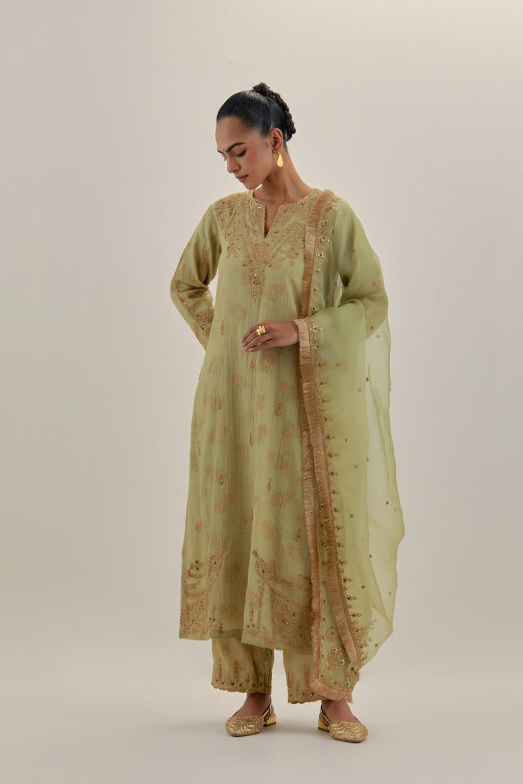 Green tissue chanderi straight kurta set, highlighted with light gold dori embroidery and hand block printed lining inside.