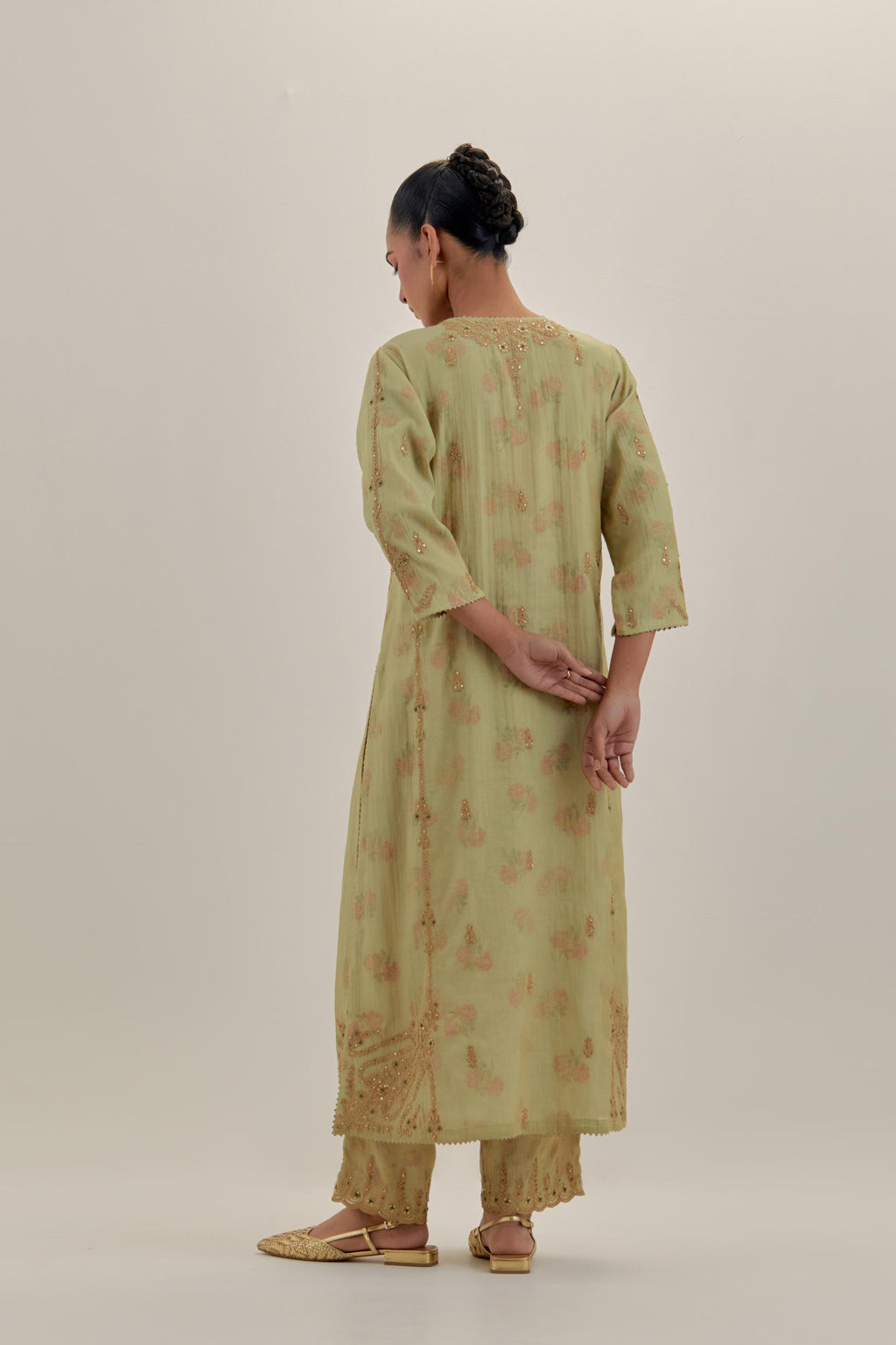 Green tissue chanderi straight kurta set with button placket neckline, highlighted with all-over light gold dori embroidery.