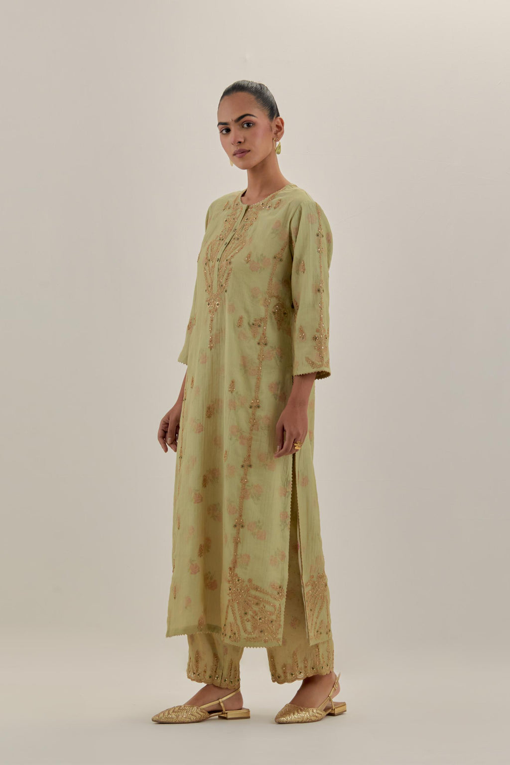 Green tissue chanderi straight kurta set with button placket neckline, highlighted with all-over light gold dori embroidery.