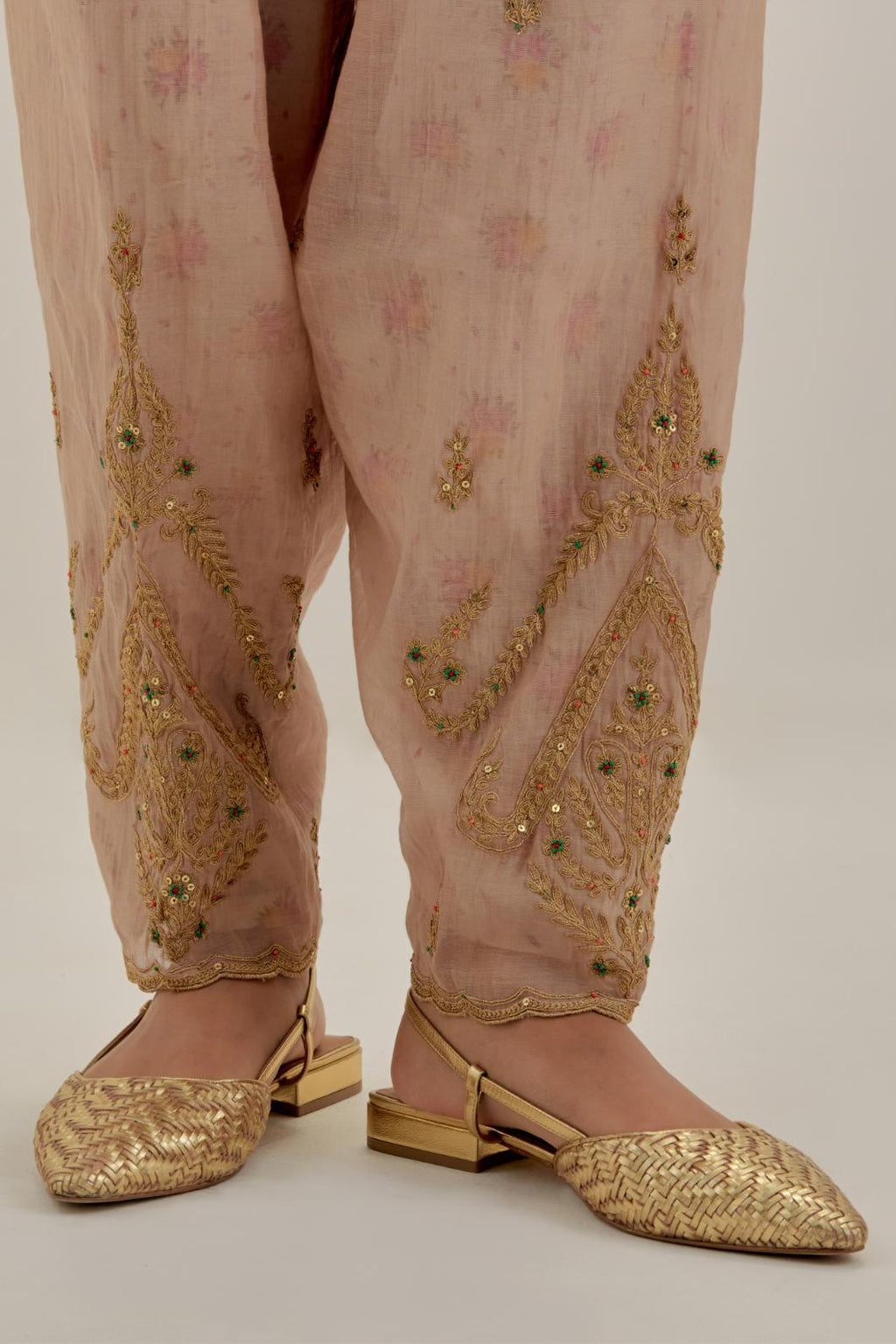 Pink tissue chanderi salwar with gold dori embroidery, highlighted with multi beads & gold sequins.